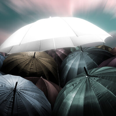 Glowing Umbrella Standing out from Dark Umbrellas Print 100% Australian Made